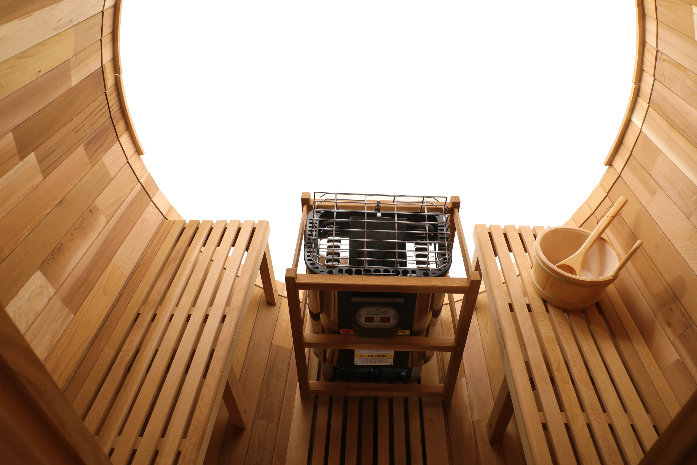 Wooden sauna interior with benches and a sauna heater.
